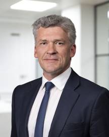 A person in a suit and tie AI-generated content may be incorrect.