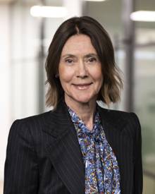 A person in a suit smiling AI-generated content may be incorrect.