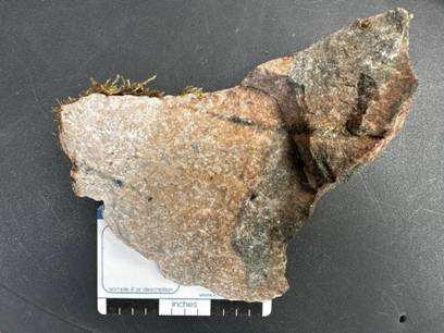 A piece of rock on a black surface AI-generated content may be incorrect.
