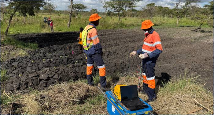 A group of men in orange uniforms standing in a field AI-generated content may be incorrect.