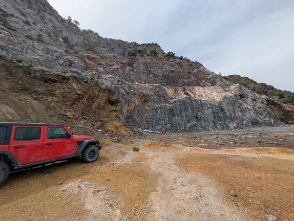 A red truck parked on a rocky hill AI-generated content may be incorrect.