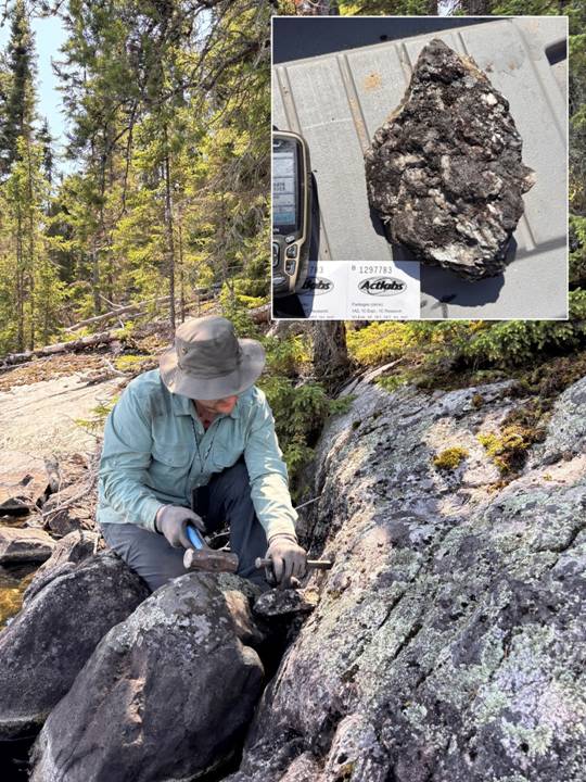A person sitting on rocks and a rock with a hammer Description automatically generated with medium confidence