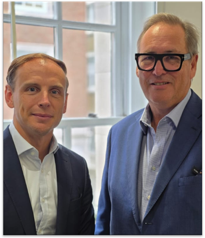 Two men in suits standing together AI-generated content may be incorrect.
