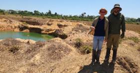 A person standing in a dirt field AI-generated content may be incorrect.