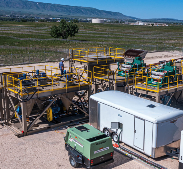 A machine and trailer in a field AI-generated content may be incorrect.