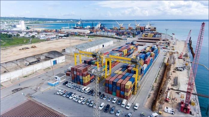 A large container terminal with cars parked in front of it AI-generated content may be incorrect.