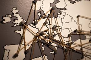 A map of the world with pins and nails AI-generated content may be incorrect.