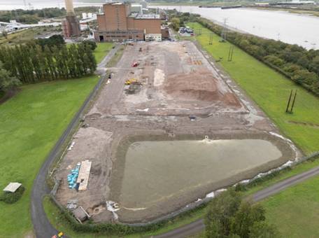 A large area with a pond and a building AI-generated content may be incorrect.