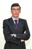 A person in a suit with his arms crossed AI-generated content may be incorrect.