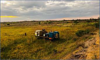 A truck in a field AI-generated content may be incorrect.