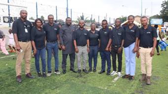 A group of people standing on grass AI-generated content may be incorrect.