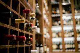 Wine bottles in a wine cellar AI-generated content may be incorrect.