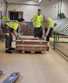 A group of people in a warehouse AI-generated content may be incorrect.