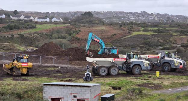 A construction vehicle with a blue excavator AI-generated content may be incorrect.
