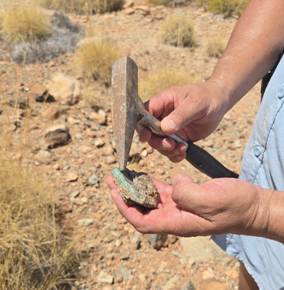 A person holding a stone with a hammer AI-generated content may be incorrect.