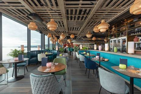 A restaurant with tables and chairs AI-generated content may be incorrect.