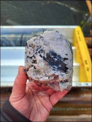 A hand holding a rock AI-generated content may be incorrect.