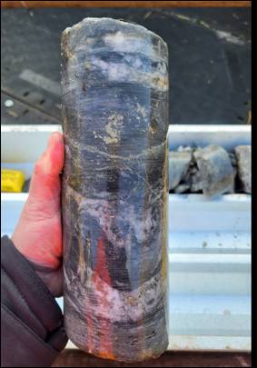 A hand holding a cylindrical object AI-generated content may be incorrect.