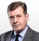 A person in a suit Description automatically generated with medium confidence