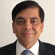 A person in a suit and tie AI-generated content may be incorrect.