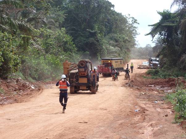 A group of construction workers on a dirt road AI-generated content may be incorrect.