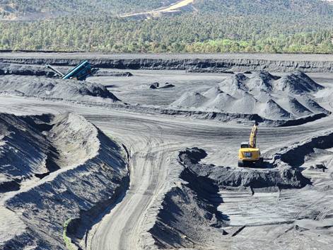 A large open pit mine with machinery AI-generated content may be incorrect.