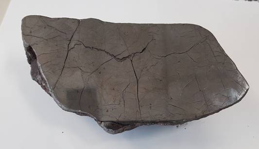 A black rectangular object with cracks AI-generated content may be incorrect.